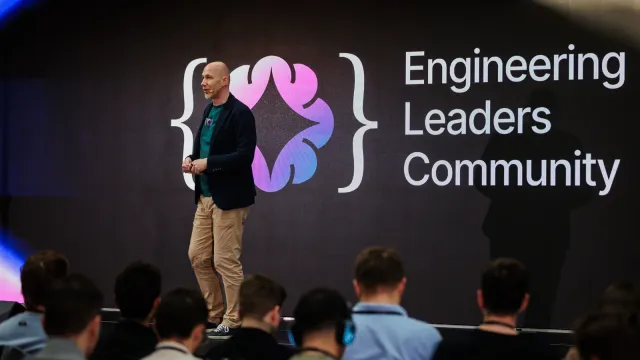 Marian Kamenistak on stage in front of the Engineering Leaders Community logo, addressing a full auditorium.