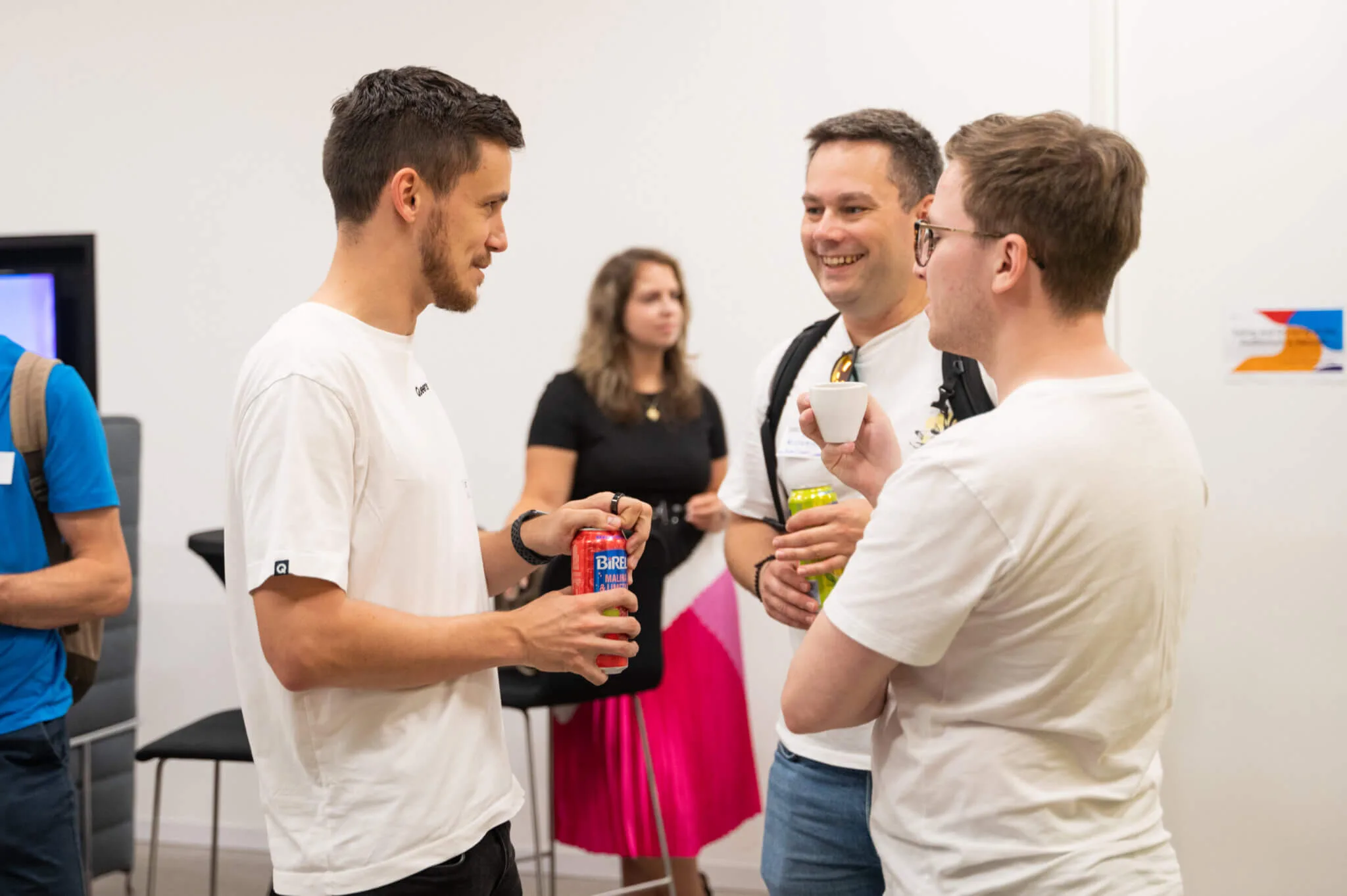 Four attendees chatting over drinks and espresso during the networking break at an ELC meetup
